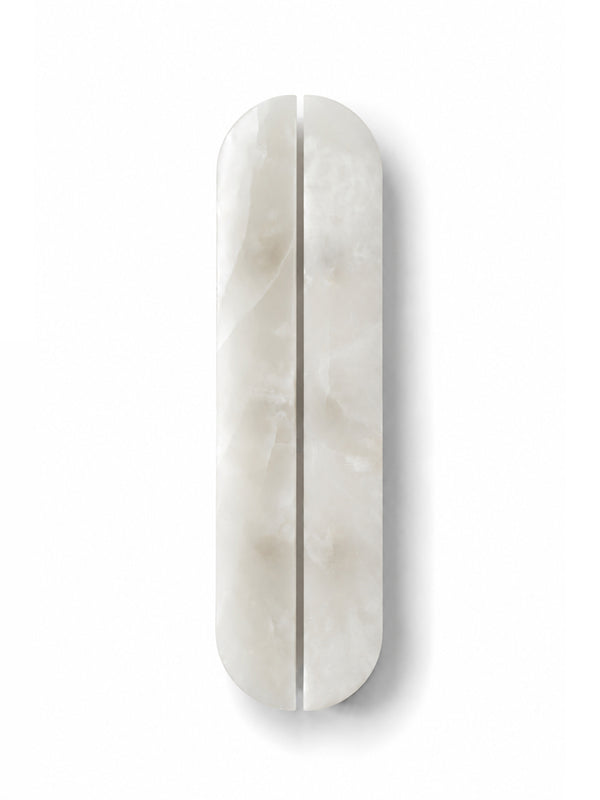 A vertically oriented, elongated oval cabinet or drawer handle made of polished white marble with a central seam, shown on a clean white background.