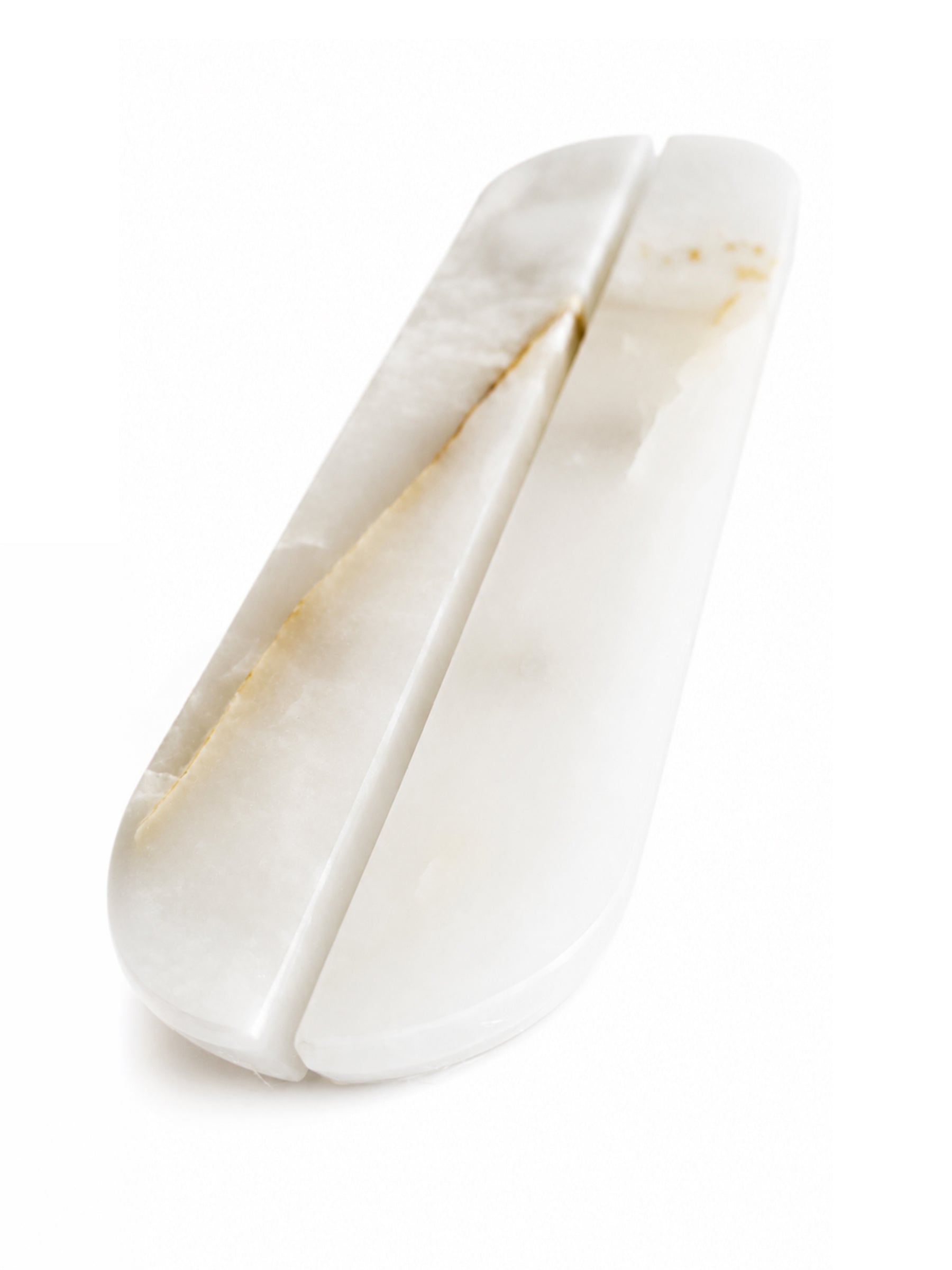 A white carved stone or bone double-edged knife with natural warm gold and beige veining, shown on a clean white background.