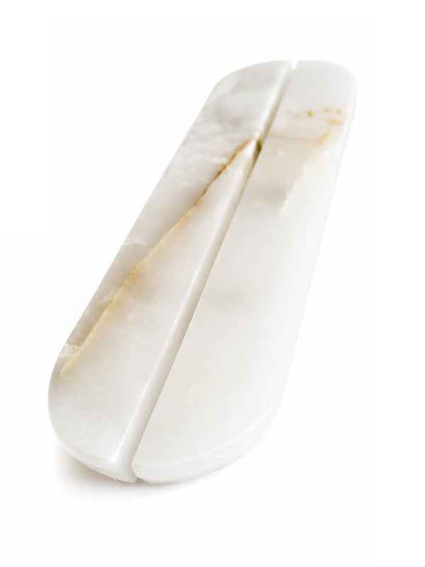 A white carved stone or bone double-edged knife with natural warm gold and beige veining, shown on a clean white background.