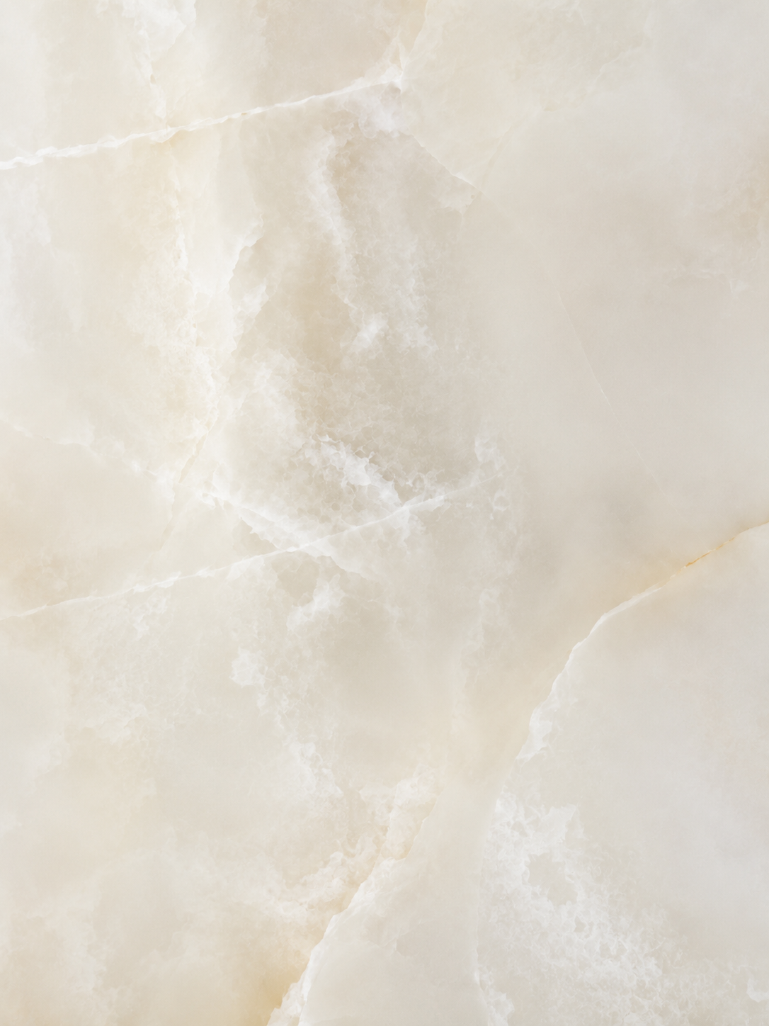 A close-up texture of a polished stone or marble surface in warm cream and beige tones with soft white veining.