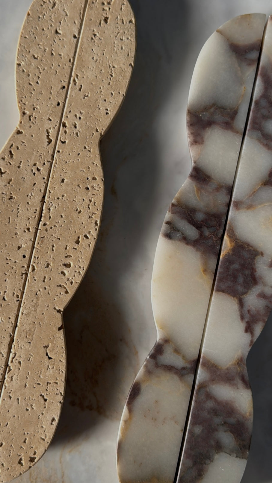 Beige travertine natural stone slab with a porous, speckled texture displayed on a marble surface.